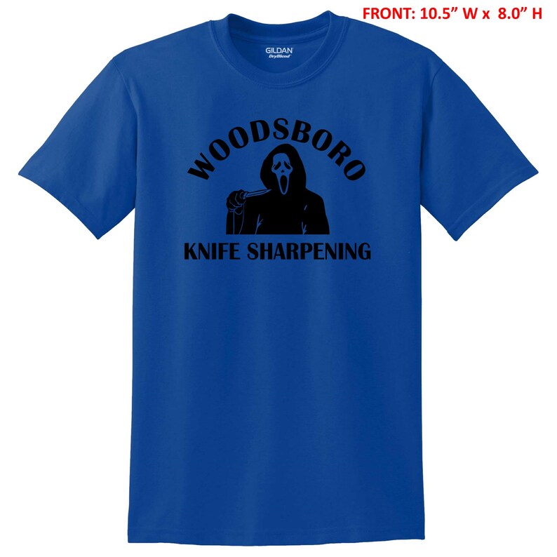 May include: A royal blue t-shirt with a black graphic of a ghost holding a knife and the text "Woodsboro Knife Sharpening".