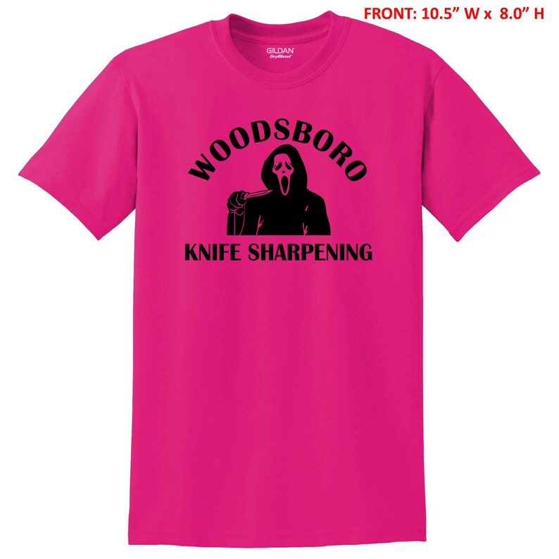 May include: Pink t-shirt with a black graphic of a ghost holding a knife and the text "Woodsboro Knife Sharpening".