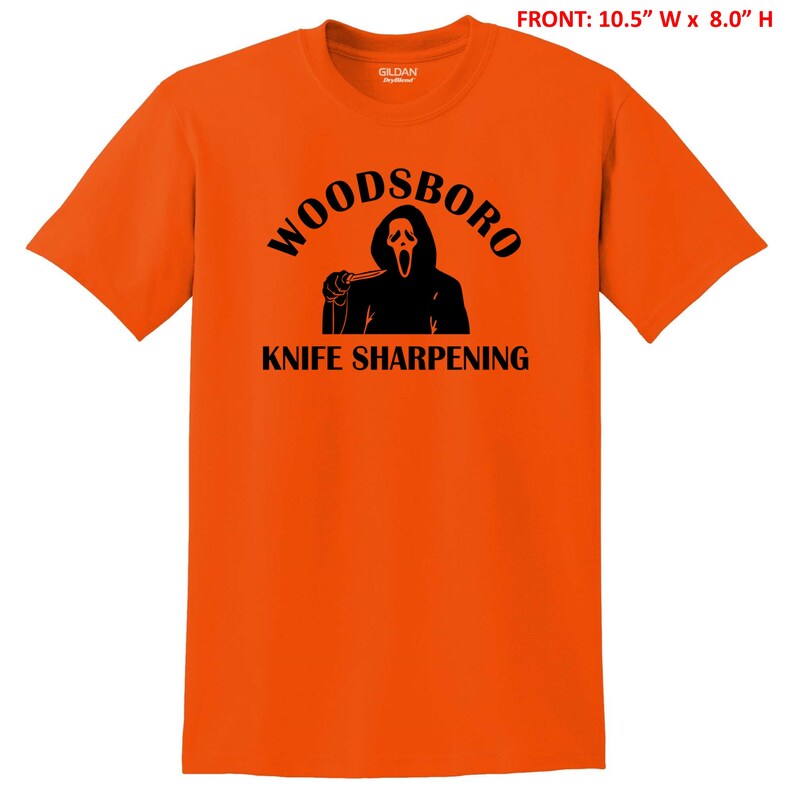 May include: Orange t-shirt with a black graphic of a ghost holding a knife and the text "Woodsboro Knife Sharpening".