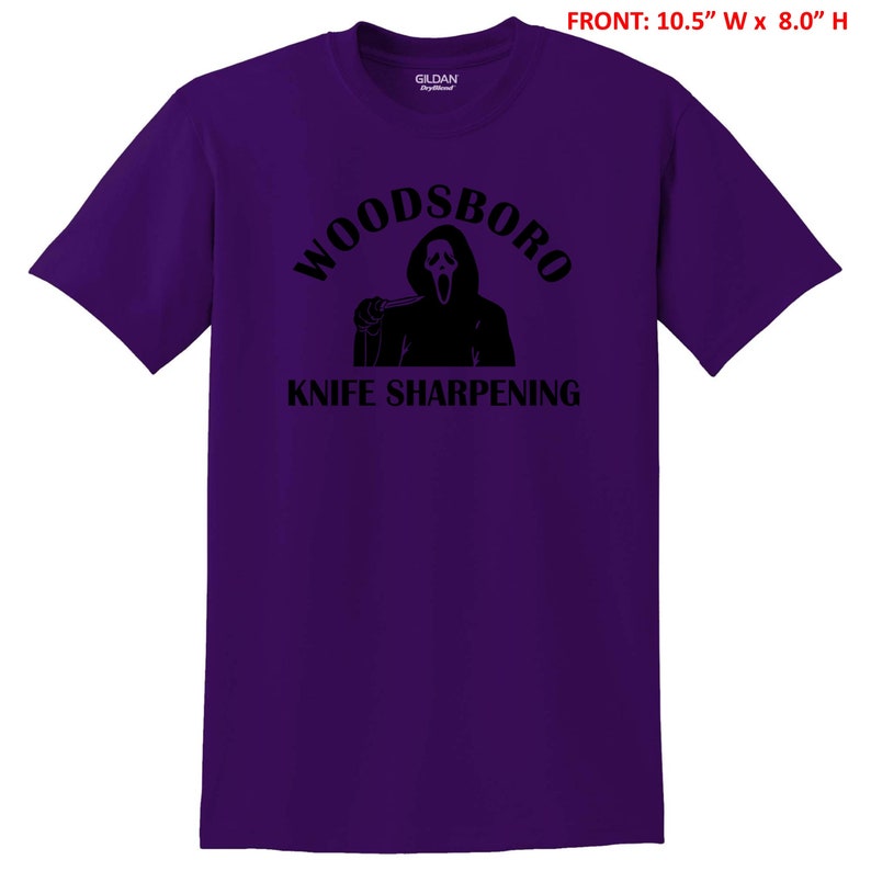 May include: Purple t-shirt with a black graphic of a ghost holding a knife and the text "Woodsboro Knife Sharpening"