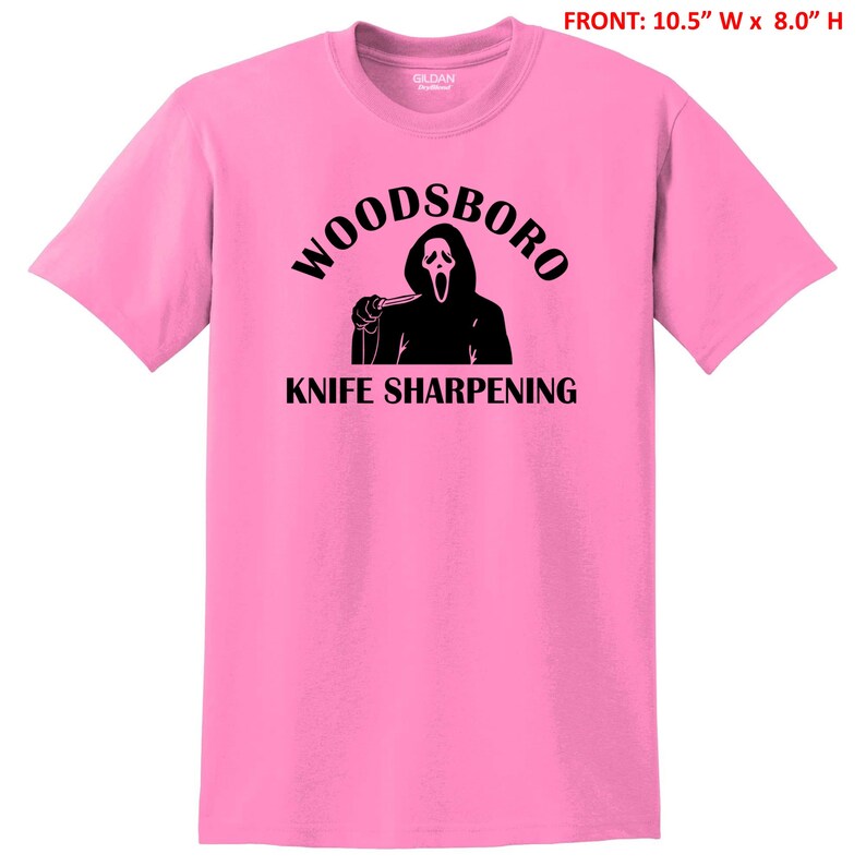 May include: Pink t-shirt with a black graphic of a ghost holding a knife and the text "Woodsboro Knife Sharpening".