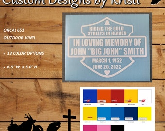 May include: A blue and white vinyl decal with the text "Riding the Gold Streets in Heaven" and "In Loving Memory of John "Big John" Smith" with the dates "March 1, 1952" and "June 20, 2022". The decal is 6.5 inches wide and 5 inches high.