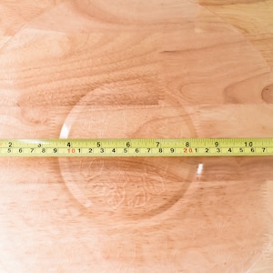 May include: A yellow measuring tape with black markings is laid across a wooden surface. The tape reads "10 11 12 13 7 8 9 10 1 2 3 4 5 6 7 8 9 20 1 2 3 4 5 6 7 8 9 30 1 2 3 4".