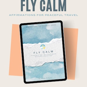 May include: A digital tablet shows the words "FLY CALM" and "AFFIRMATIONS FOR PEACEFUL TRAVEL." The screen displays a watercolor design with the text "FLY CALM" and "Transform fear into confidence and enjoy the journey."