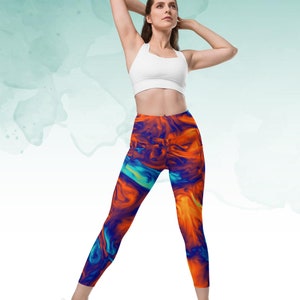 May include: A pair of colorful leggings with a blue, orange, and yellow abstract pattern. The leggings are made of a stretchy, comfortable fabric and are perfect for yoga, running, or any other workout.