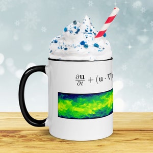 May include: White ceramic mug with a black handle. The mug has a graphic of a mathematical equation and a colorful abstract image. The mug is topped with whipped cream and a red and white striped straw.