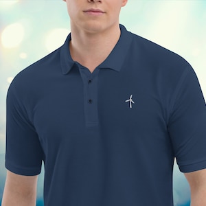 May include: A dark blue polo shirt with a small white wind turbine graphic on the chest.