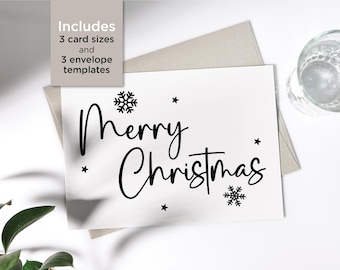 May include: A white card with black text that reads "Merry Christmas". The card has a snowflake design and stars.