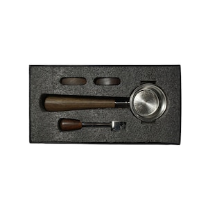 May include: A stainless steel espresso portafilter with a wooden handle, two tamper bases, and a cleaning tool in a black foam-lined box.