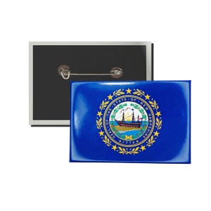 May include: A blue and gold button featuring the state seal of New Hampshire. The seal depicts a ship with a white sail and a yellow sun rising over the ocean. The text "Seal of the State of New Hampshire" and "1776" are inscribed around the ship.