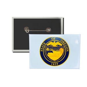 May include: A blue and gold button with the State of Oregon seal. The seal features an eagle, a sunrise, and the words "State of Oregon" and "1859".