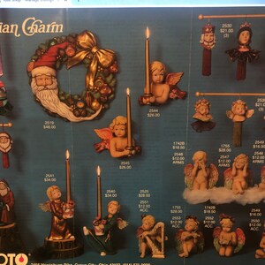 May include: A collection of Victorian-style Christmas ornaments, including angels, cherubs, Santa Claus, and a wreath. The ornaments are made of painted ceramic and feature intricate details. The ornaments are displayed on a white background.