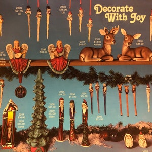 May include: A collection of hand-painted ceramic Christmas decorations featuring a variety of themes, including angels, deer, Santa Claus, and trees. The decorations are decorated with bright colours and intricate details. The text "Decorate With Joy" is displayed at the top of the image.