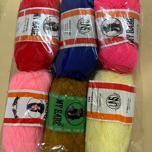 May include: Six balls of acrylic yarn in various colors, including red, blue, pink, light pink, brown, and yellow. Each ball has a label with the brand name "MY BABE" and the text "ACRYLIC YARN" in English.