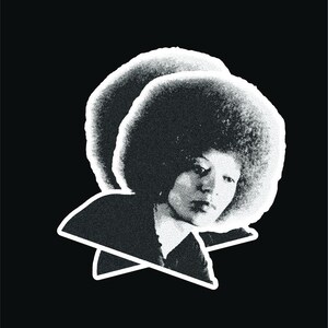 May include: Black and white portrait of a person with an afro hairstyle. The person is looking down and has a serious expression.