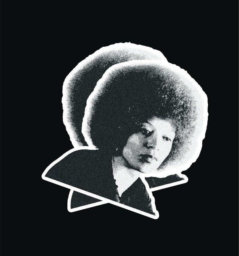 May include: Black and white portrait of a person with an afro hairstyle. The person is looking down and has a serious expression.