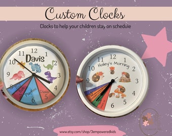 May include: Two custom clocks with colorful designs. One clock features a dinosaur theme with the name "Davis" and the other clock features a hedgehog theme with the text "Hailey's Morning".