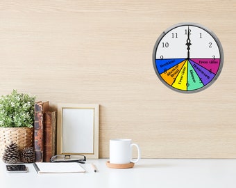 May include: A colorful clock divided into sections for different activities, such as bedtime, shower, free time, dinner, and homework. The clock face is white with black numbers and hands. The sections are colored red, orange, yellow, green, and purple.