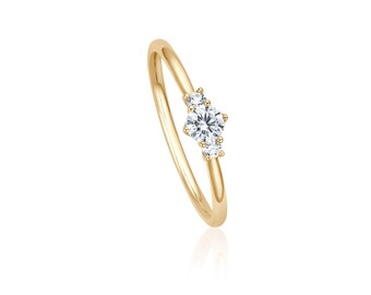May include: A delicate gold band ring with three round-cut diamonds. The center diamond is larger than the two smaller diamonds on either side.