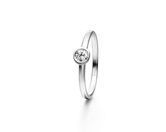 May include: A simple silver ring with a single round clear stone set in a bezel setting.