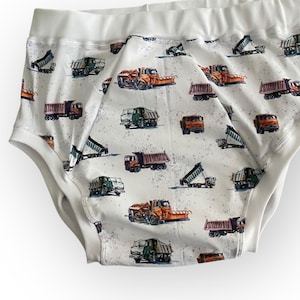 May include: White cotton underwear with a repeating pattern of orange, brown, and green dump trucks.