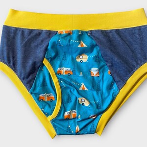 May include: Blue and yellow underwear with a pattern of orange camper vans and trees on a blue background.
