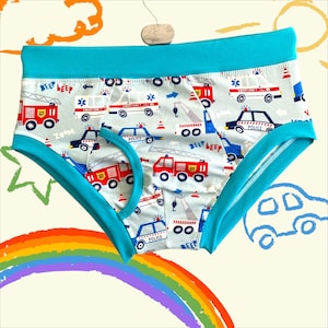 May include: Blue and white underwear with a repeating pattern of emergency vehicles, including fire trucks, ambulances, and police cars. The text "Beep Beep" appears on the underwear.