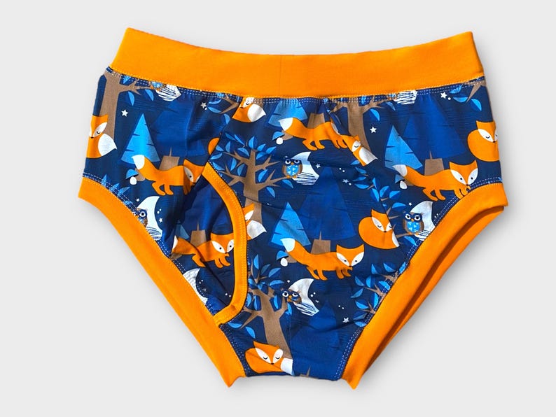 May include: Blue and orange underwear with a repeating pattern of foxes, owls, and trees.