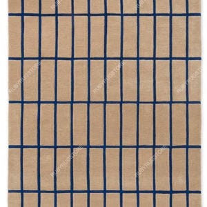 May include: Beige rectangular rug with a grid pattern of navy blue lines. The rug has a soft, textured appearance, suitable for living rooms or bedrooms. The design is modern and geometric.