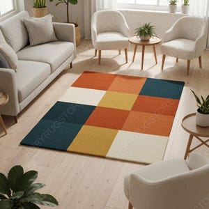 May include: A patterned rug featuring a grid design in shades of orange, yellow, teal, and cream. The rug is placed in a living room with light-coloured furniture and wooden flooring. The rug's dimensions are suitable for a medium-sized space.