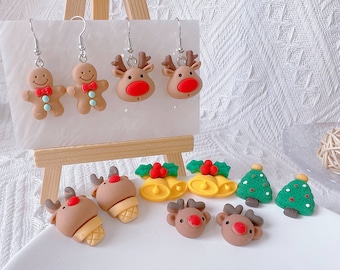 May include: A collection of Christmas-themed earrings and charms. The earrings include gingerbread men and reindeer designs. Other charms include Christmas trees, bells, and reindeer heads. The items are in shades of brown, red, green, and yellow.