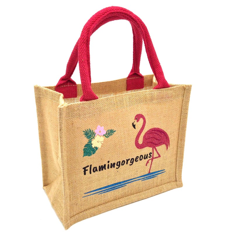Natural colour jute bag with pink handle. Displays a pink flamingo using glitter htv, standing in a glitter blue lake, with flowers to one side, personalised with flamingorgeous in a black glitter font.