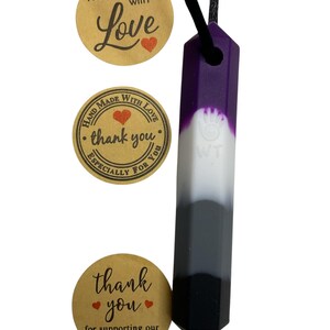 May include: A multi-colored pendant necklace with a black cord. The pendant is a rectangular prism with a gradient of purple, white, gray, and black. The image also includes three round stickers with text that reads "handmade with Love", "thank you", and "thank you for supporting our small business".