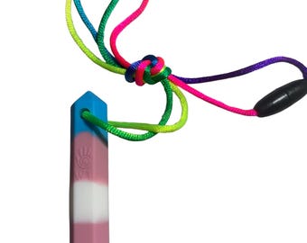 May include: A blue, white, and pink pendant with a rainbow cord. The pendant has the text "WT" and a hand symbol. The cord is tied in a knot and has a black clasp.