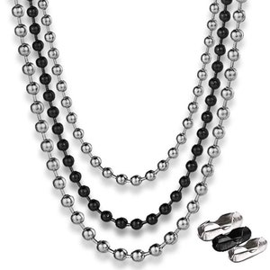 May include: Three layered necklace featuring silver and black ball chains. The chains are made of small, round beads and are displayed against a white background. The necklace has a modern and minimalist design, suitable for everyday wear.
