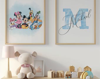 May include: Two framed prints with wooden frames. One features Disney characters like Mickey and Minnie Mouse, Donald Duck, and Goofy. The other print has a blue letter "M" with the name "Michael" in cursive. The prints are displayed above a white dresser.