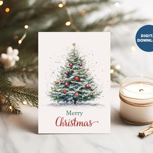 May include: A Christmas card with a watercolour illustration of a decorated Christmas tree, adorned with red baubles and a gold star. The words "Merry Christmas" are written in red script. A candle and greenery are in the background.
