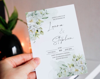 May include: A white wedding invitation with floral accents and the names "Laura & Stephen" in elegant script. The invitation includes the date, time, and location: Saint Anthony's Church, Boston, MA.