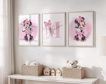May include: Three framed Minnie Mouse prints in a nursery setting. Each print features Minnie in a pink polka-dot dress and bow, set against a pink watercolor background. The middle print includes the name "Madison".