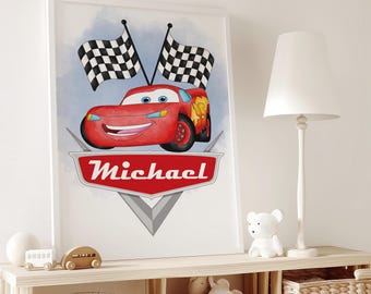 May include: A framed print featuring a red cartoon race car with a smiling face, checkered flags, and the name "Michael" in a red emblem. The background has a light blue watercolor effect. The print is displayed on a wooden shelf.