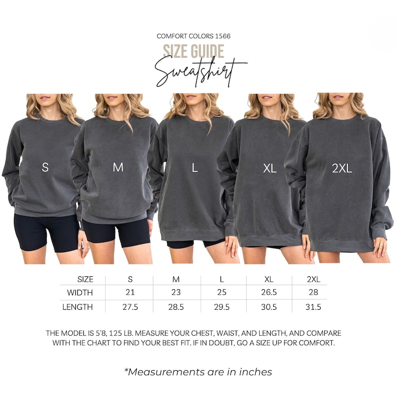 K&ouml;nnte beinhalten: Eine Gr&ouml;&szlig;entabelle f&uuml;r ein graues Comfort Colors 1566 Sweatshirt. Das Bild zeigt f&uuml;nf Sweatshirts in den Gr&ouml;&szlig;en S, M, L, XL und 2XL. Die Gr&ouml;&szlig;entabelle enth&auml;lt Breiten- und L&auml;ngenma&szlig;e in Zoll. Das Model ist 172.7 cm, 56.7 kg.