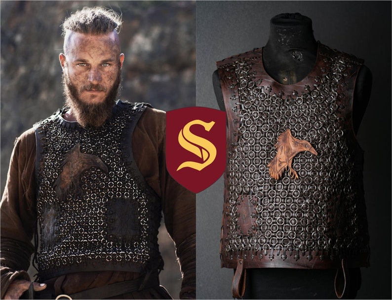 May include: A dark brown leather vest featuring a chainmail-style construction with interconnected metal rings. The vest includes a prominent embossed raven emblem on the chest and leather trim along the edges, displayed on a mannequin form.