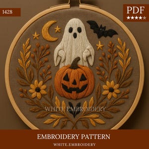 May include: Embroidered Halloween design in a wooden hoop. Features a smiling jack-o'-lantern, a friendly ghost, and a bat. Includes a crescent moon, stars, and floral accents in shades of orange, yellow, and brown. The text "WHITE EMBROIDERY" is visible.