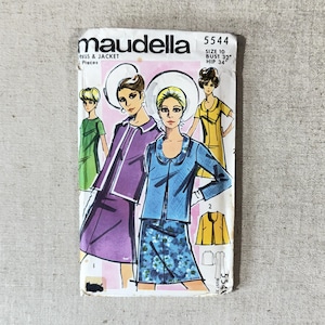 May include: Vintage Maudella dress and jacket sewing pattern. The package features illustrations of women in dresses and jackets. The pattern is size 10, with a 32-inch bust and 34-inch hips. The package is on a neutral background.