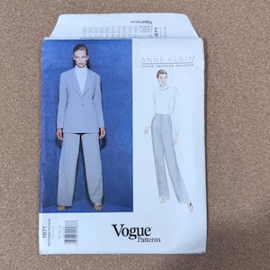 May include: A Vogue Patterns sewing pattern featuring a suit designed by Anne Klein. The pattern includes a blazer and wide-leg pants. The cover shows a woman wearing the suit. The pattern number is 1871.