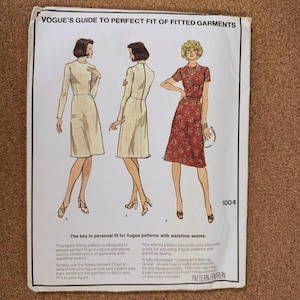May include: A vintage Vogue sewing pattern guide titled "Vogue's Guide to Perfect Fit of Fitted Garments." The cover features illustrations of three women in dresses. The text includes instructions for personalizing patterns with waistline seams.