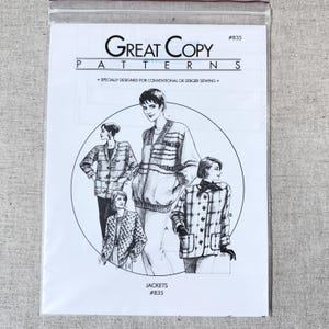 May include: A sewing pattern packet for jackets. The packet is white with the text "Great Copy Patterns" and illustrations of four jacket designs. The packet is sealed in a clear plastic bag.