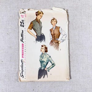 May include: Vintage Simplicity pattern 2962, featuring illustrations of women's blouses and vests. The pattern includes size 14 and bust 32 measurements. The cover is aged with wear and tear, showcasing retro fashion designs.