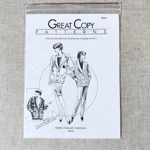 May include: A white sewing pattern packet for a shawl collar cardigan. The packet features illustrations of the cardigan and includes the text "Great Copy Patterns" and "Shawl Collar Cardigan #840". The packet is sealed in a clear plastic bag.