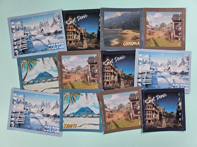 May include: A collection of ten vintage-style postcards featuring various locations from the video game Red Dead Redemption 2. The postcards are printed on thick cardstock and feature a variety of scenic locations, including Saint Denis, Rhodes, and Tahiti. Each postcard has a unique design and features the name of the location in a stylized font.